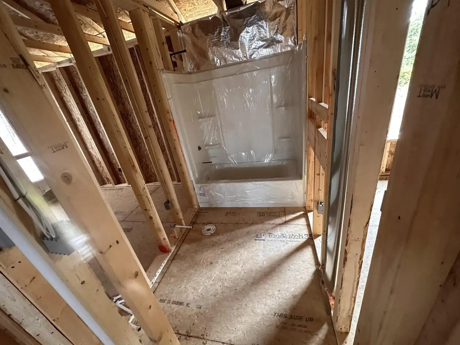 Clean and Dusted post-construction cleanup in a framed home with cleaning supplies